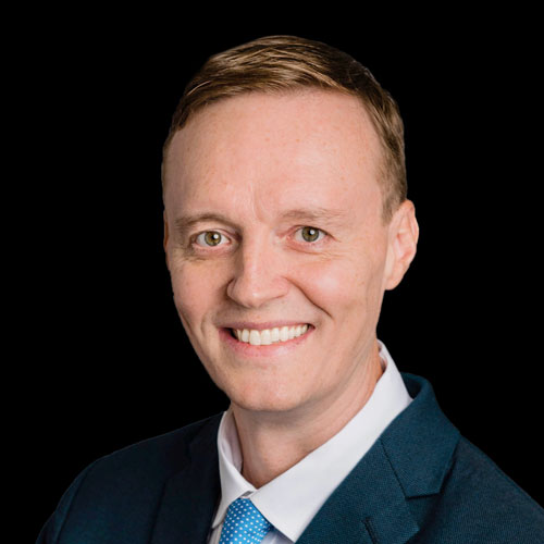 Professional headshot of ophthalmologist Dr. Michael B. Horsley, in a blue suit and tie, smiling in front of a black background.