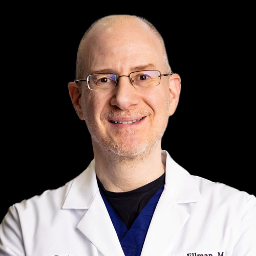Professional headshot of ophthalmologist Dr. Marc Ellman, wearing a white coat and glasses, smiling against a black background.