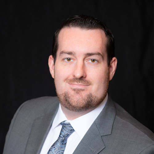 Headshot of Dr. Hunter Sherlock, optometrist at Southwestern Eye Center, smiling in a suit and tie with a clean, professional appearance.