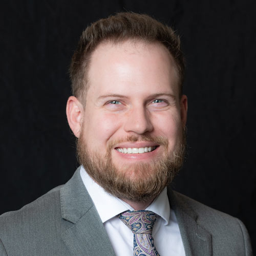 Professional Headshot of Dr. Landon Montierth, OD against a black backdrop.