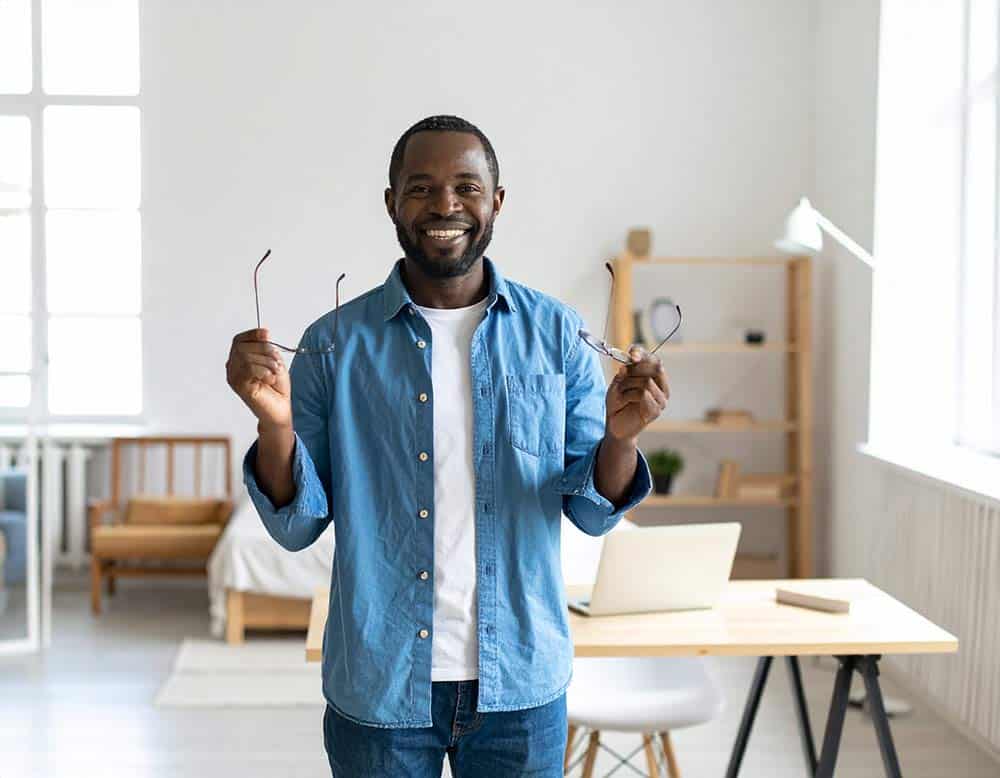Image of a man excited that he isn't restricted by glasses anymore.