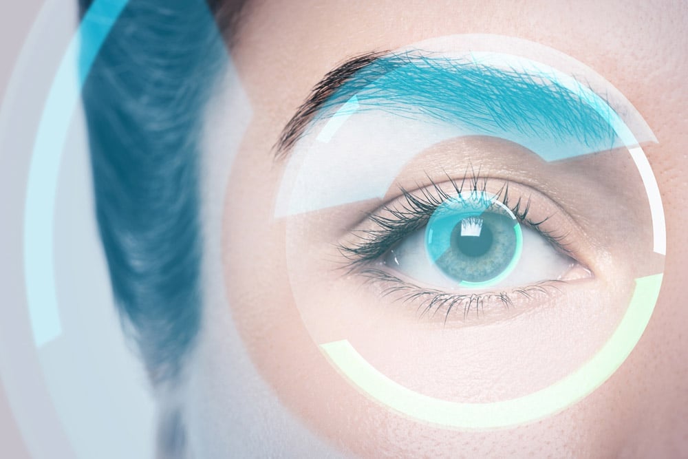 Close-up of a turquoise eye surrounded by circular holographic overlays.