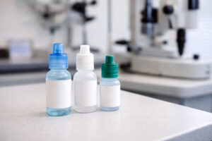 three lubricating eye drop bottles for ocular surface disease on a counter at Southwestern Eye Center