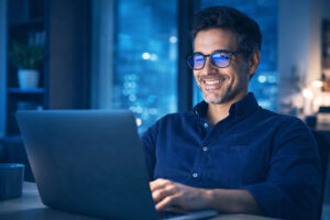 Man working comfortably from digital eye strain after learning about lens coatings and the effectivenesses of blue-light blocking glasses from Southwestern Eye Center in Phoenix, Arizona.