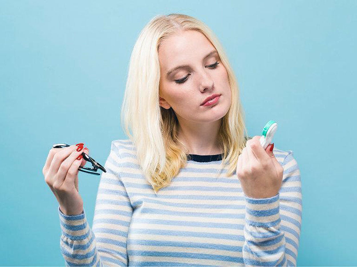 Young woman considering switching from glasses to contacts after learning more from Southwestern Eye Center.