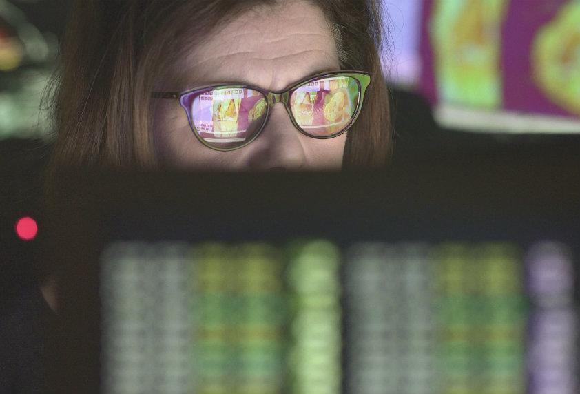 Person wearing glasses looking at computer screen with digital eye strain from prolonged screen use.