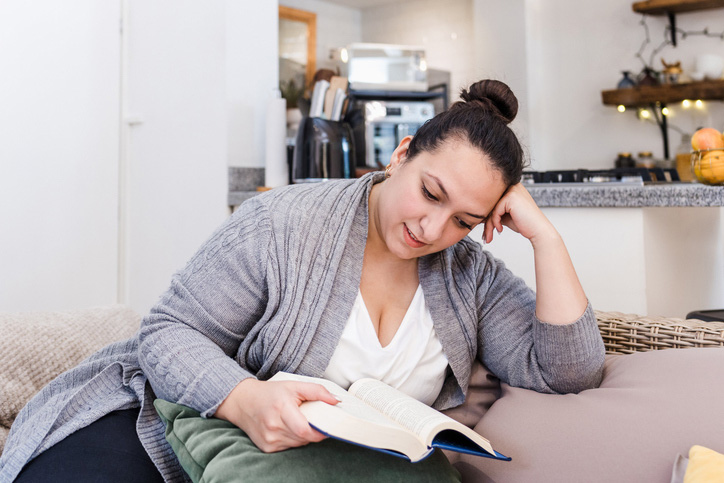 Patient reading comfortably at home after advanced glaucoma surgery treatment.