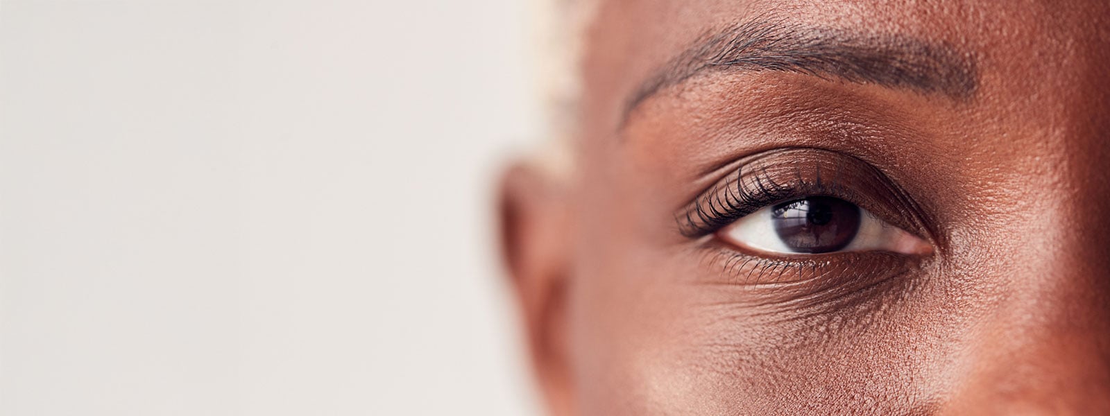Close up of an african american woman who has a history of glaucoma in her family.