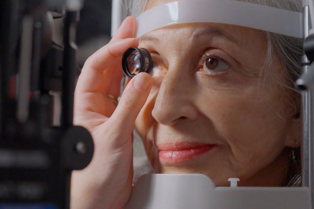 Close-up of patient during a routine vs comprehensive eye exam testing vision and eye condition