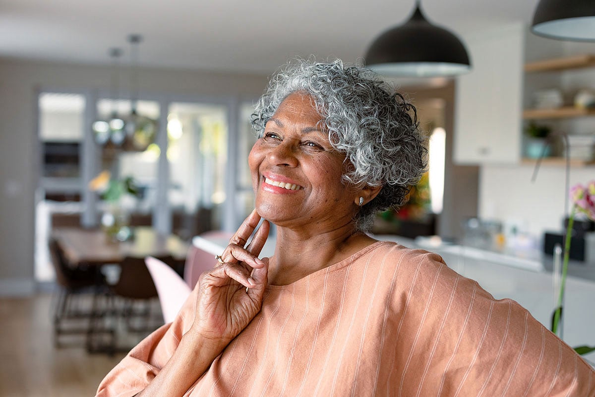Can you get a cataract after cataract surgery? Senior woman enjoying clear vision at home after treatment at Southwestern Eye Center.
