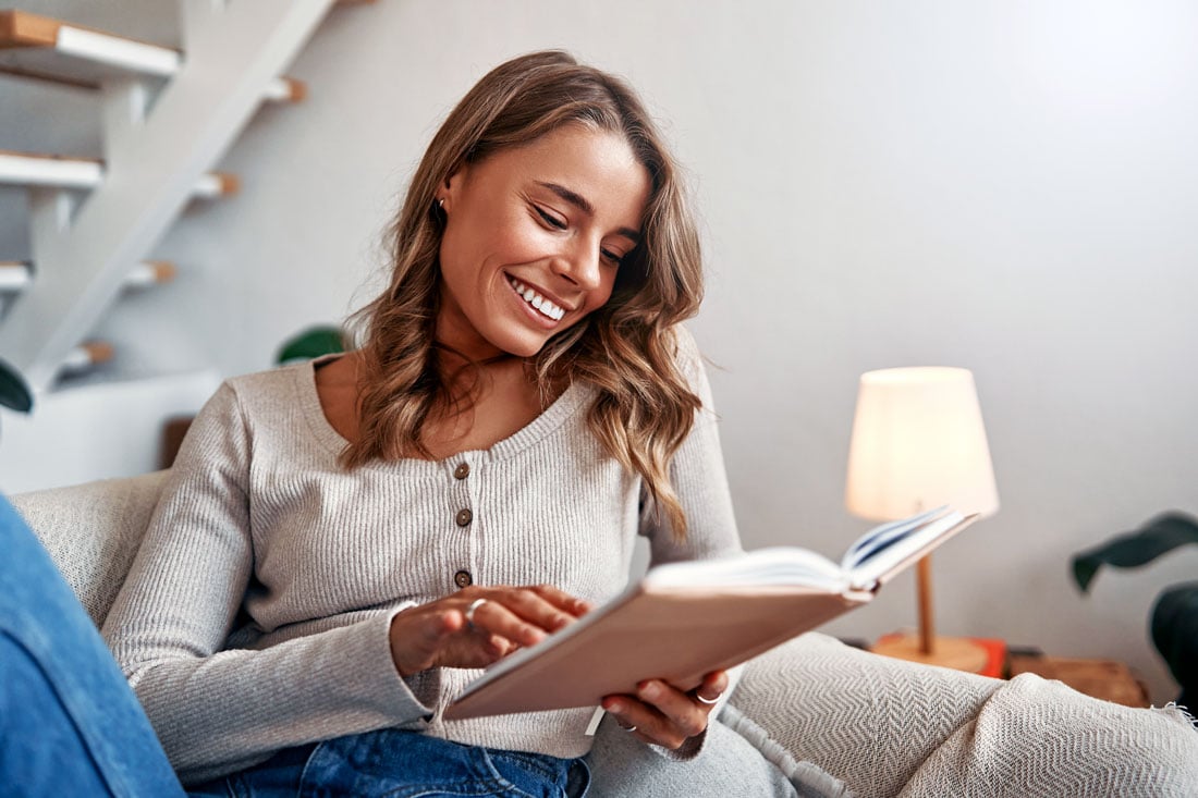 Woman reading at home, highlighting interesting facts about eyes and how vision focuses at near.