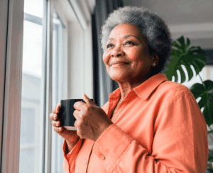Senior woman relaxing with coffee at home after learning more about early-onset catr