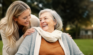 Senior woman happy to see her granddaughter after learning about Medicare covering cataract surgery costs at Southwestern Eye Center.
