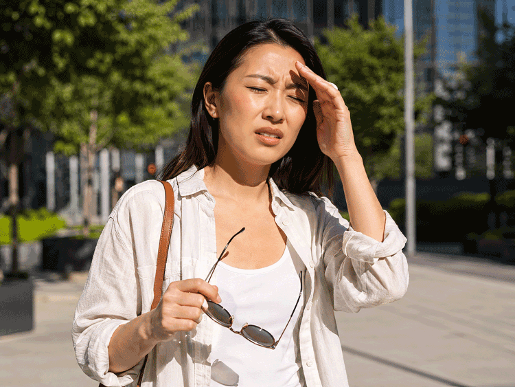 Asian woman suffering from light sensitivity and eye pain seeks treatment from Southwestern Eye Center.